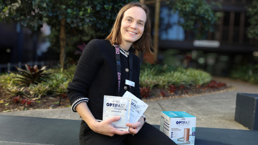 Margie Conley Dietitian holding meal replacement kit