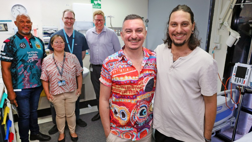 Kidney specialist group of support worker, surgeon, and nephrologists in clinic with live kidney donor Sajarn and his brother Cody who received the kidney transplant. 