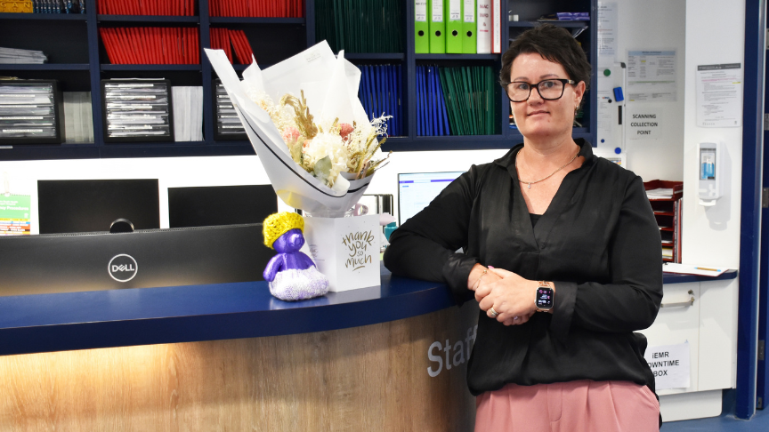 Woman standing beside reception desk