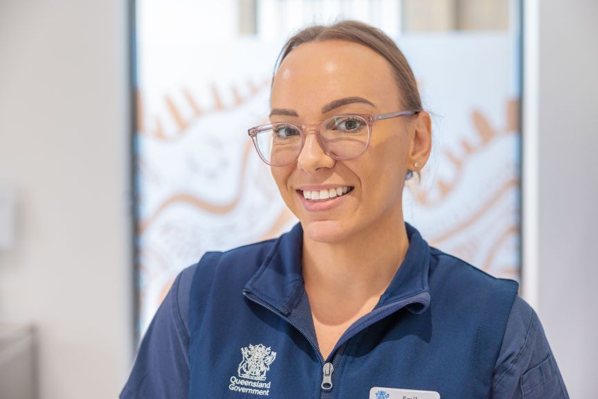 Headshot of female nurse in uniform smiling at camera