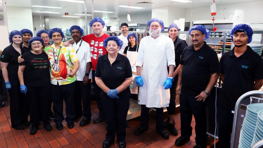Food Services staff gathered in industrial kitchen