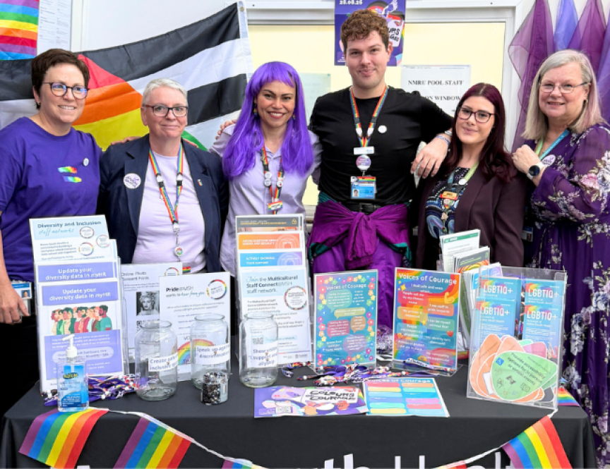 a small group of people wearing and standing in front of Wear it Purple merchandise