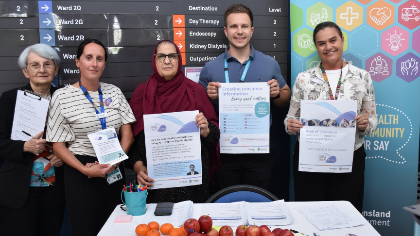 Group of people in mixed clothing holding paperwork about health literacy