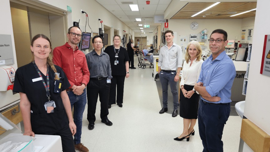 A group of healthcare professionals stands in a hospital hallway, representing the Integrated Theranostics Centre at PA Hospital