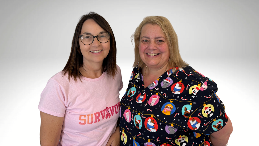 Breast cancer survivor and healthcare professional standing side by side, smiling