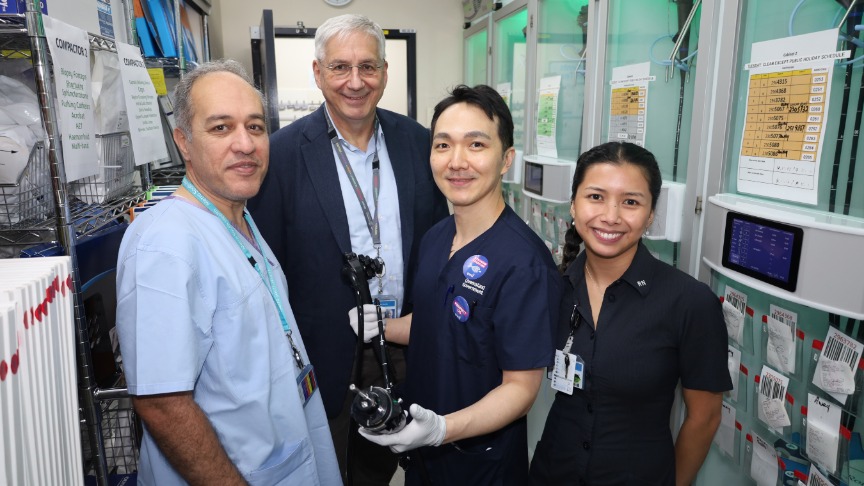 Four gastroenterology staff members in scrubs holding a medical device in a hospital setting at PA Hospital