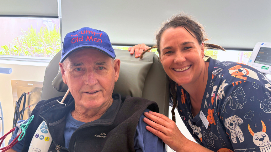Smiling staff member with male patient in chair