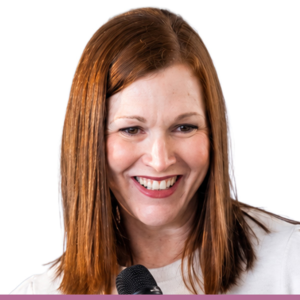 A person with shoulder length ginger hair, shown from the shoulders up against a white background.