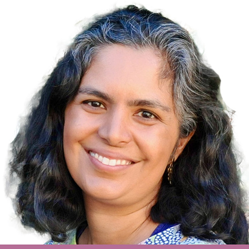 A person with dark shoulder length hair, shown from the shoulders up against a white background.