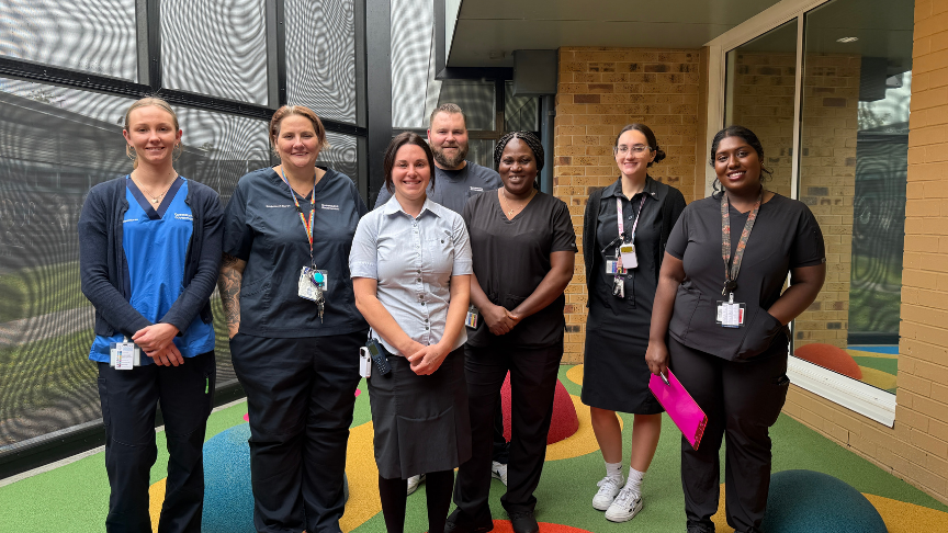 Mixed gender group of healthcare workers standing outside