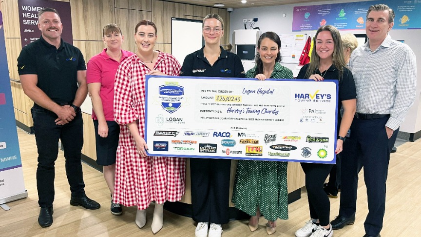Group of people holding a giant cheque