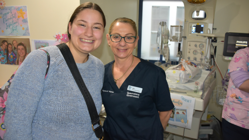 New graduate students stand with staff at Logan Hospital Open Day