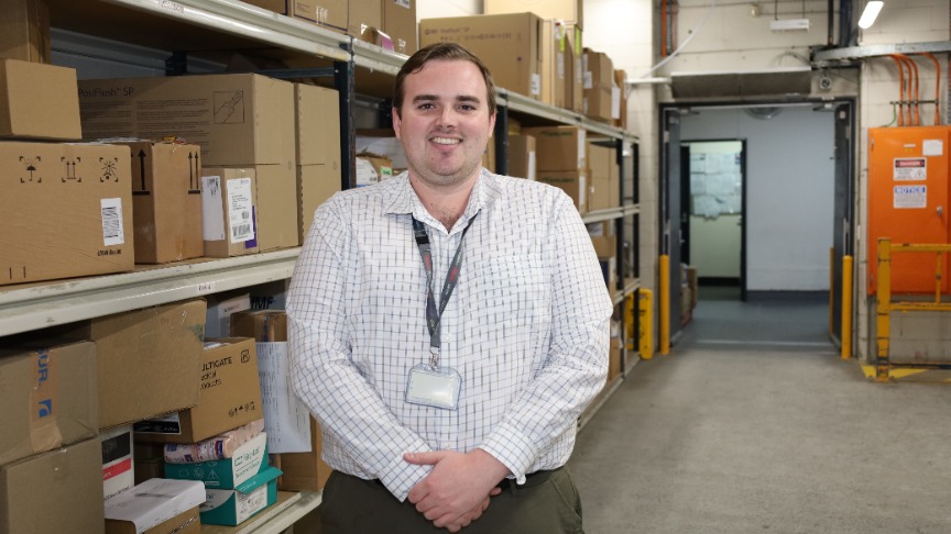 Male worker standing in hospital supply dock.