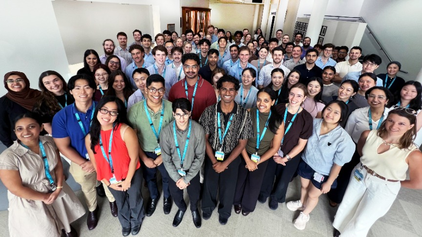 A diverse group of medical interns at PA Hospital, standing together inside a foyer