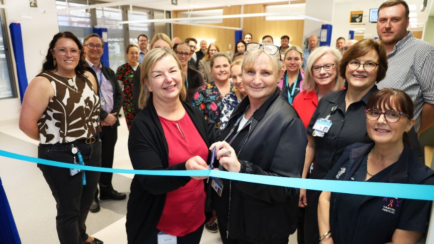A group of people cutting a ribbon to celebrate the opening of a new space at PA Hospital