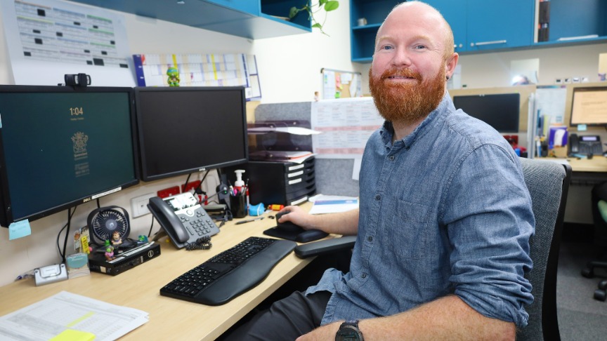 man sitting at computer smiling