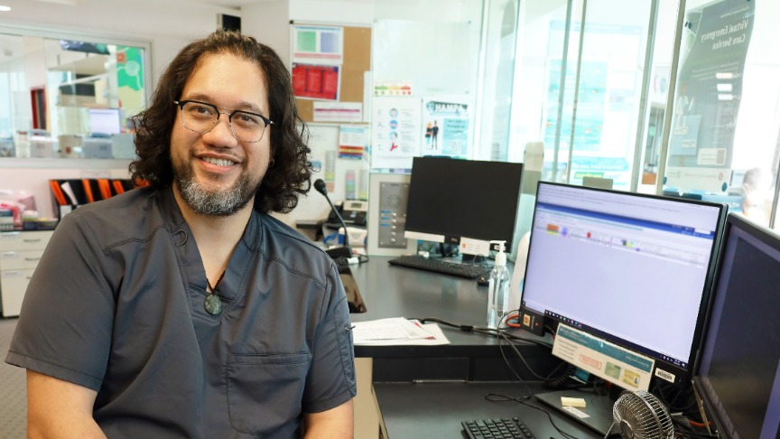 Administrative officer sitting at computer smiling