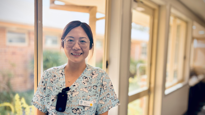 Smiling female clinician in outpatient ward