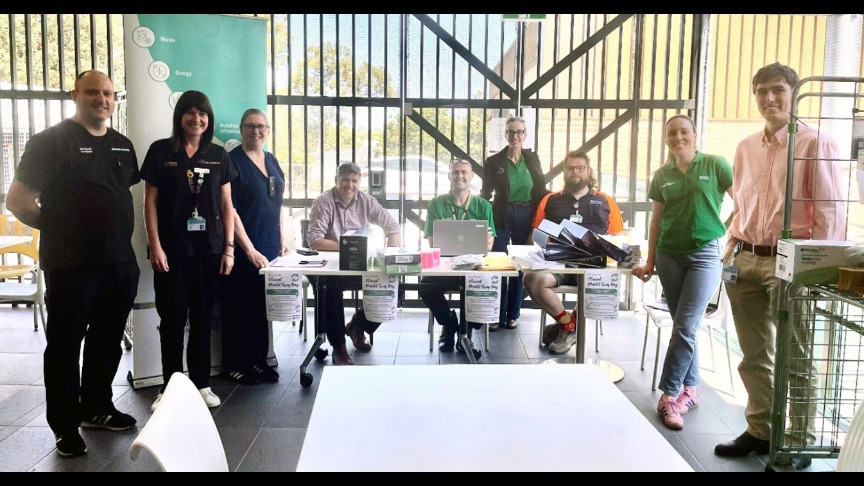 QEII MDT gathered around table in indoor/outdoor dining area.