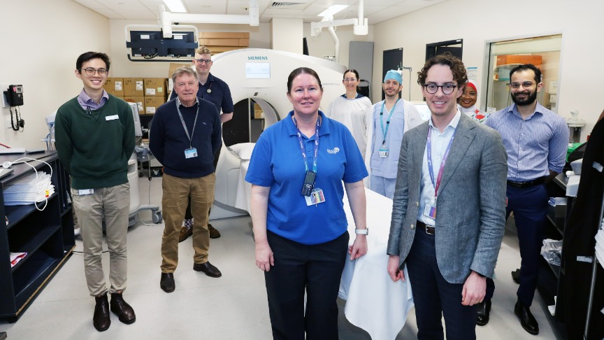 A group of medical professionals stands together in a hospital room, representing the stroke team at a PA Hospital
