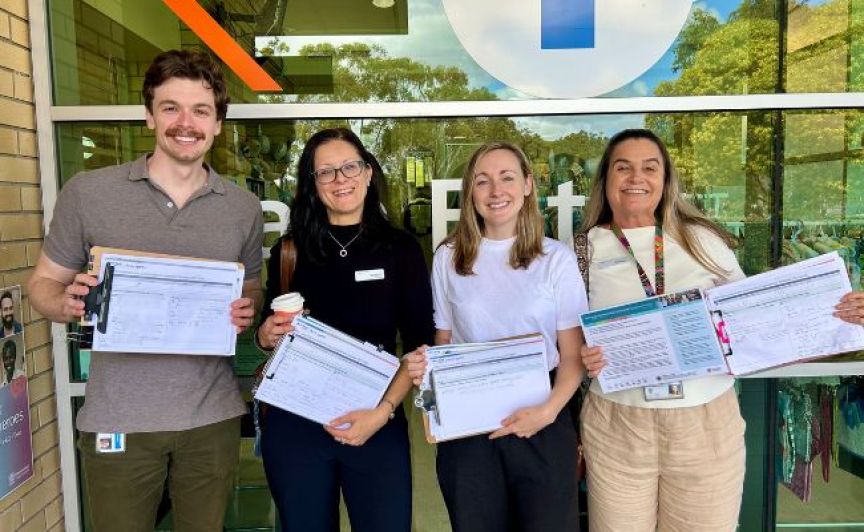 Group picture of staff with survey results