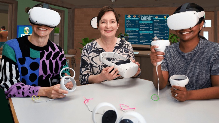 Three women, speech pathologists, wearing virtual reality headsets, engaged in a collaborative session at a table