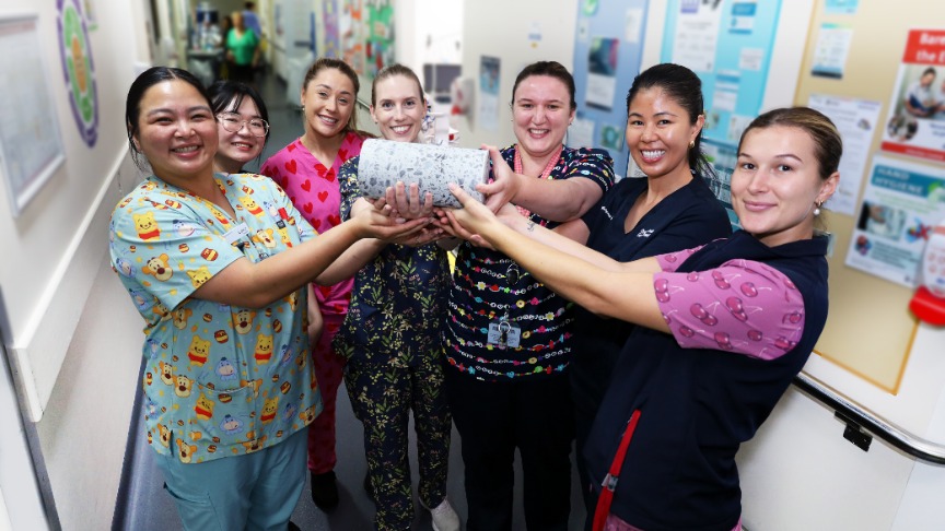  A group of nurses at PA Hospital proudly hold a cement cylinder celebrating a milestone of expansion works