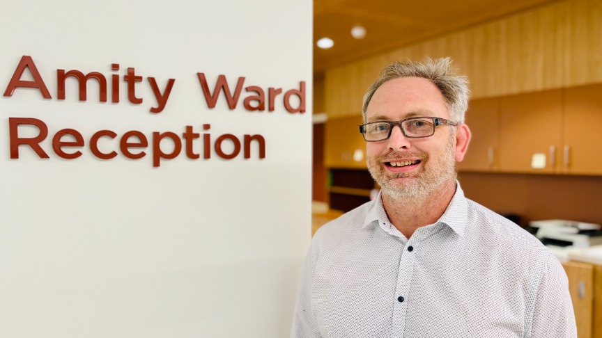 Male doctor in new ward reception area