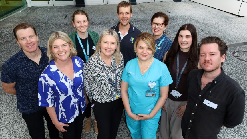 A group of mental health staff members standing in front of a PA hospital building