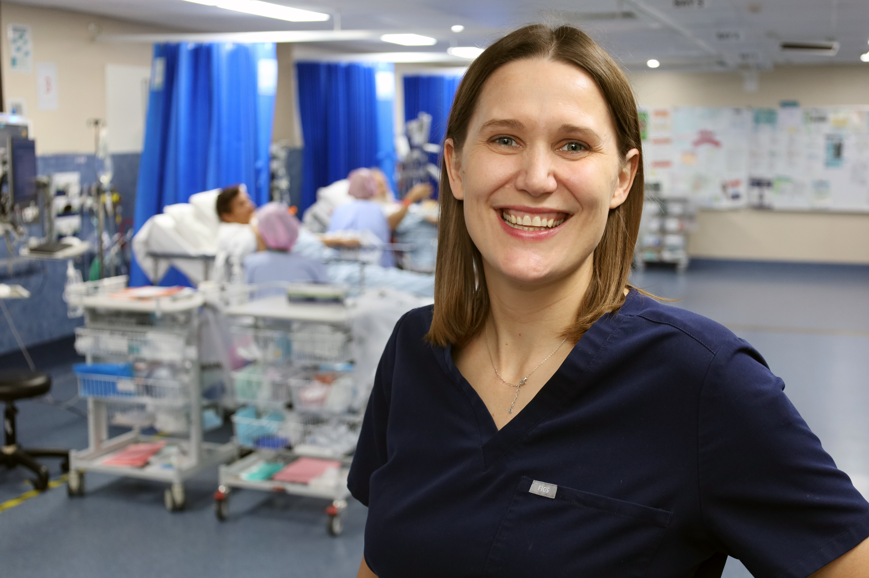 Dr Katie Christensen smiling in a clinical space at QEII Hospital.