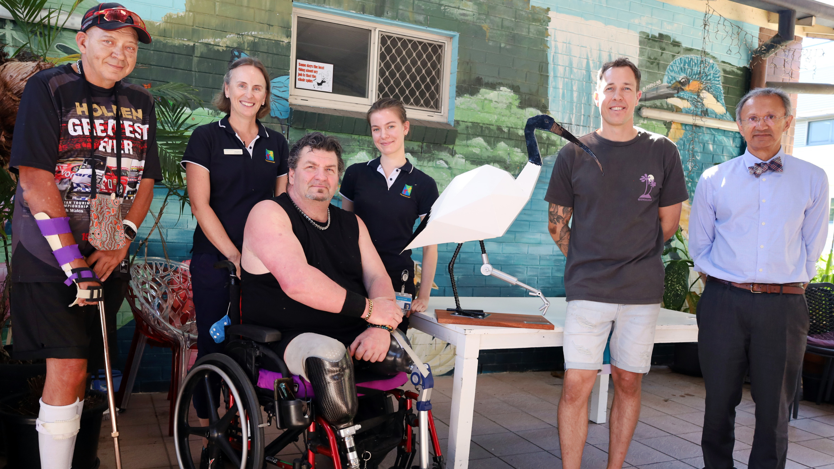 Staff and patients at PA Hospital with donated ibis sculpture on table