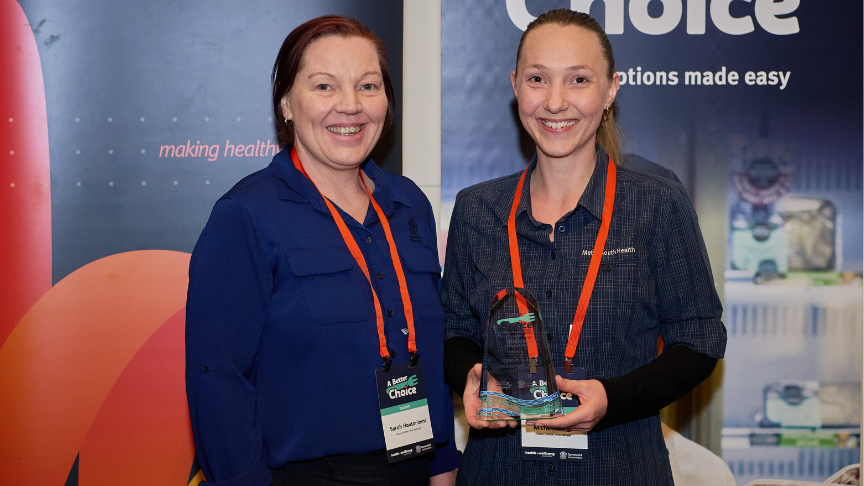 Two women holding a trophy 