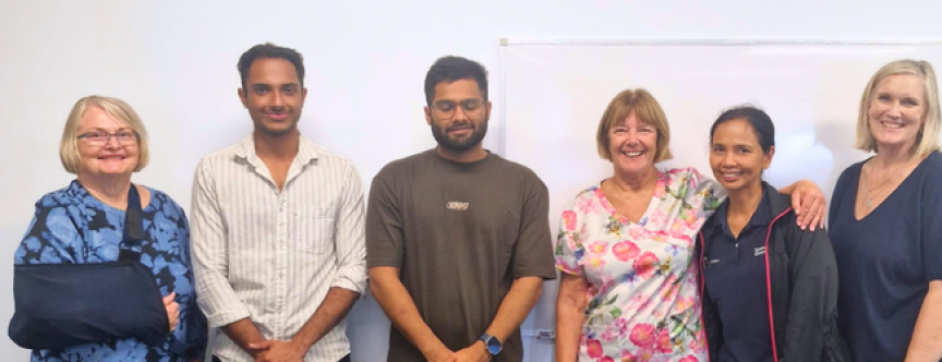 A group of clinical staff standing against a wall
