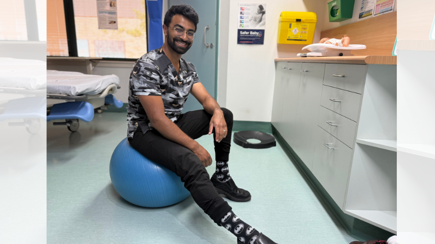 A male doctor sitting on a gym ball showing off his socks