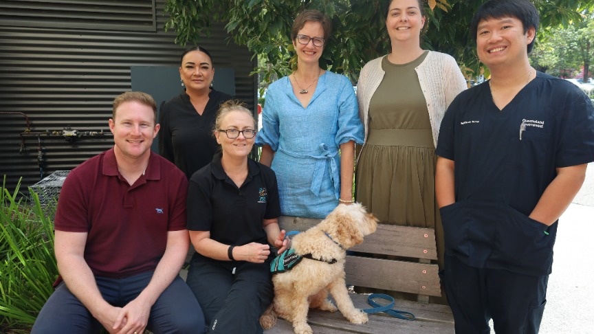 CGU Team standing together and smiling at QEII Hospital