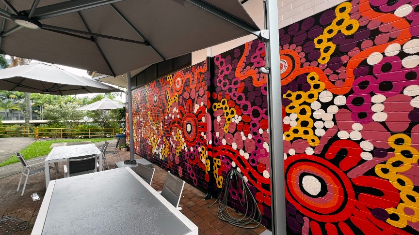 First Nations artwork mural in the spinal injuries unit courtyard featuring vibrant colours