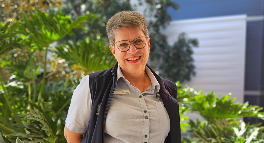 Experienced female nurse stands in the garden of Redland Satellite Hospital where community cancer services were established 