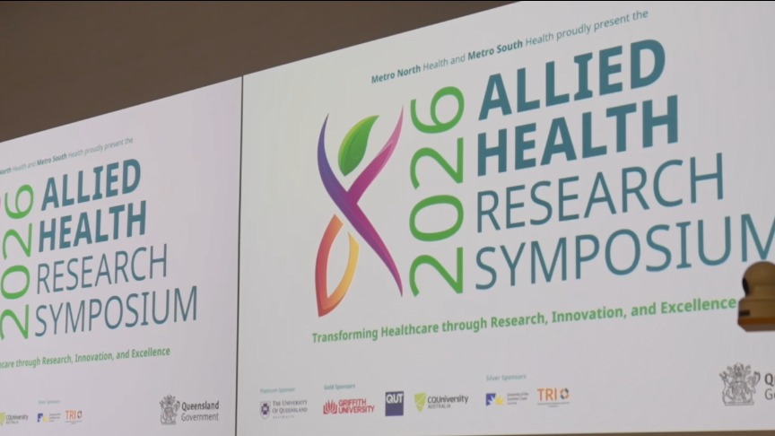 Projector screen displaying Allied Health Research Symposium title slide