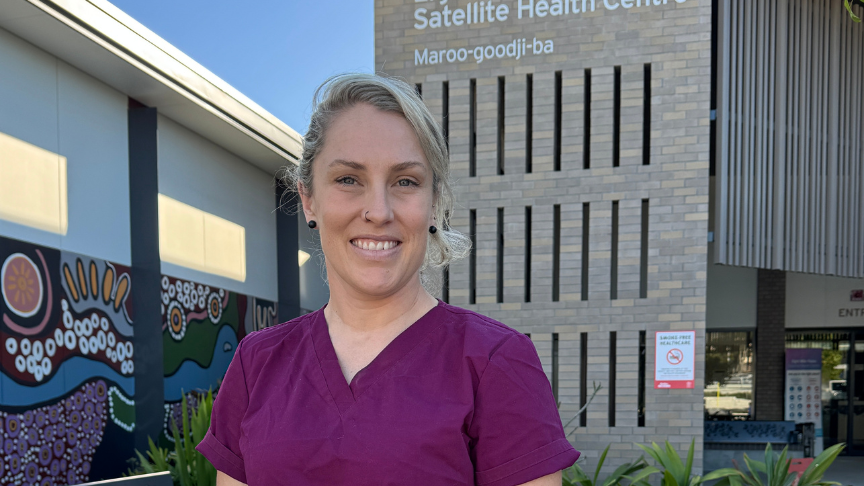 Headshot of a female nurse standing outside a health facility