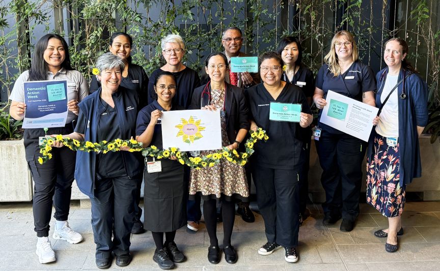 large group of health professionals, some with sunflower accessories 