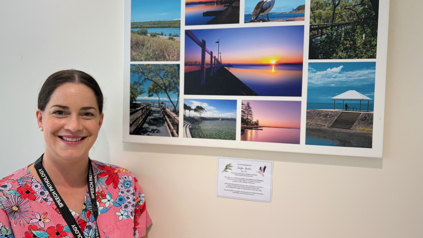 Female staff member standing next to artwork featuring pictures of Redland City 
