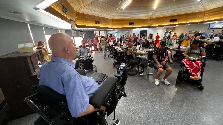 Spinal injury patients and other guests gathered in large dining room