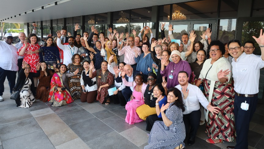 A group of staff celebrates the 30-year anniversary of Queensland Transcultural Mental Health Centre with a group photo