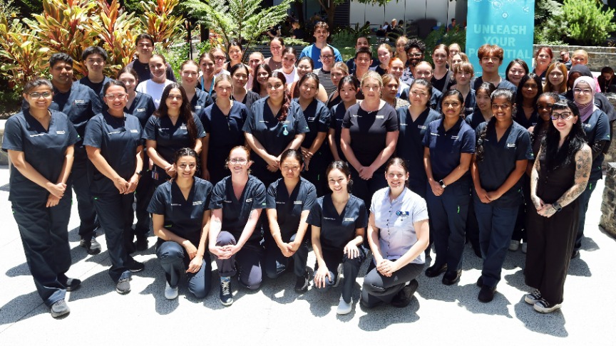 A group of new nurse graduates in scrubs poses for a photo at PA Hospital, celebrating their achievement for 2026