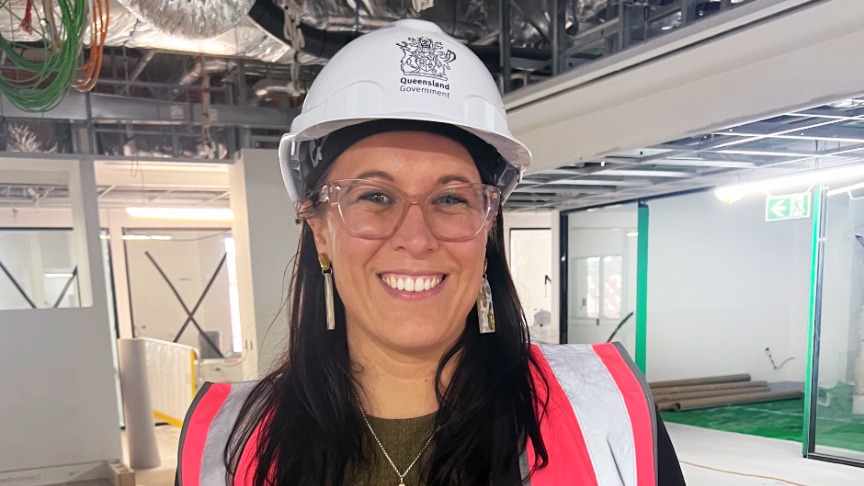A woman wearing high visibility PPE in a hospital construction zone