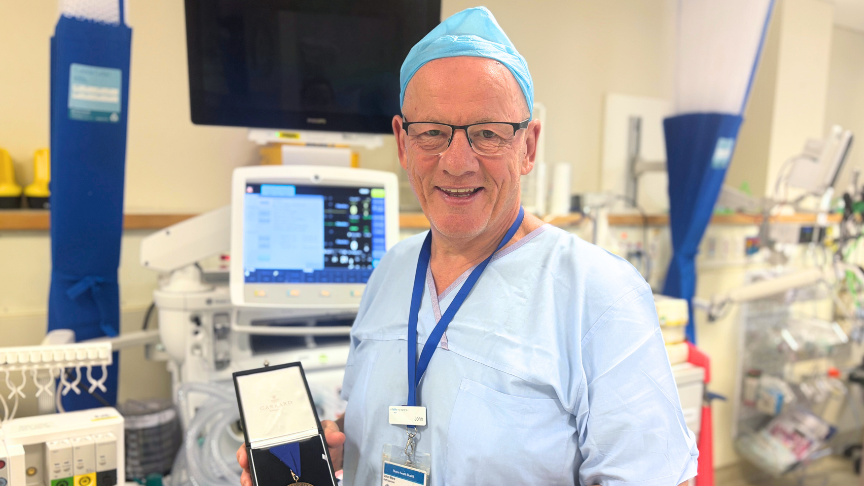 Dr John Ward proudly displays his international Anniversary Medal in the Redland Hospital operating theatre.