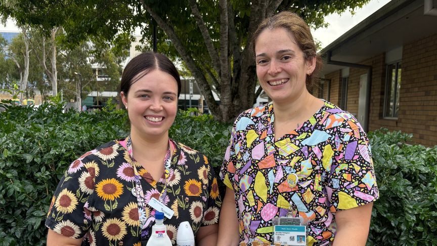 two female staff members in bright scrubs