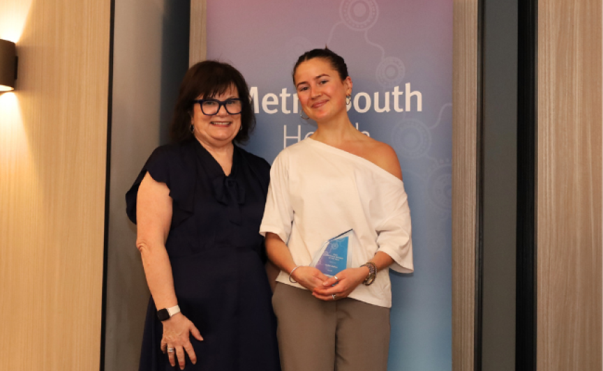 Photograph of female nurse receiving award